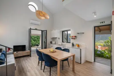 a kitchen and dining room with a table and chairs at OurMadeira - Casa Hortensia in Senhora do Rosário