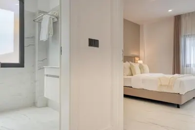 a white bedroom with a bed and a shower at Beco Santa Emilia 1C, a Home in Madeira in Funchal