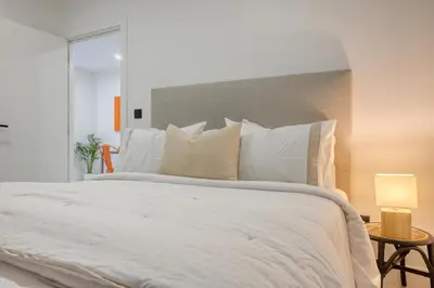 a bedroom with a large white bed with white pillows at Beco Santa Emilia 1C, a Home in Madeira in Funchal