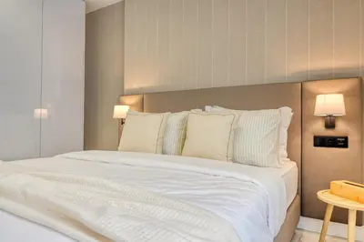 a bedroom with a large bed with white sheets and pillows at Beco Santa Emilia 1C, a Home in Madeira in Funchal