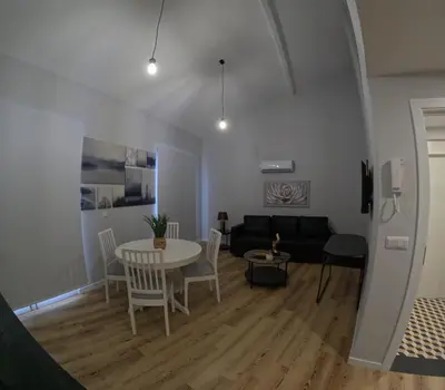 a living room with a table and a couch at Pretas Village Flats in Funchal