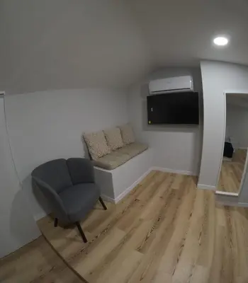 a room with a couch and a tv and a chair at Pretas Village Flats in Funchal