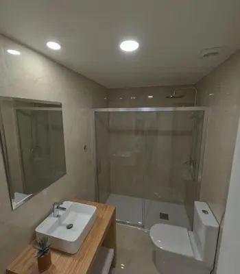 a bathroom with a toilet and a sink and a shower at Pretas Village Flats in Funchal