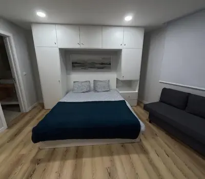 a bedroom with a bed and a couch at Pretas Village Flats in Funchal