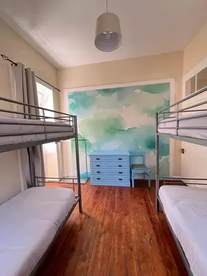 a bedroom with two bunk beds and a mural at Lazareto 148 Hostel in Funchal