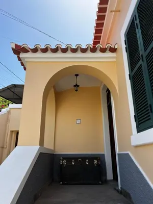 a entry to a house with a black door at Lazareto 148 Hostel in Funchal