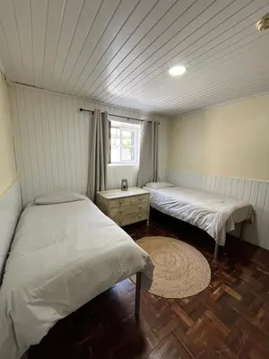 a bedroom with two beds and a window at Lazareto 148 Hostel in Funchal