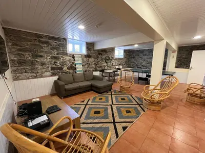 a living room with a couch and a table and chairs at Lazareto 148 Hostel in Funchal