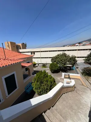 a view of a building with a patio and plants at Lazareto 148 Hostel in Funchal