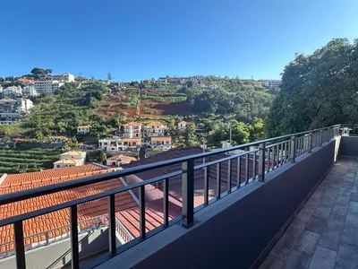 a house with a balcony on top of a building at Casa Rodrigues in Funchal