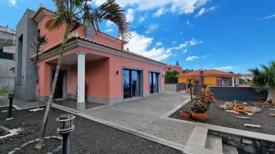 a pink house with a palm tree in front of it at Mon Rêve Portugais by LovelyStay in Funchal