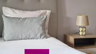 a bed with a pillow and a lamp on a night stand at Mon Rêve Portugais by LovelyStay in Funchal
