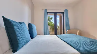a bedroom with a bed with blue pillows at Mon Rêve Portugais by LovelyStay in Funchal
