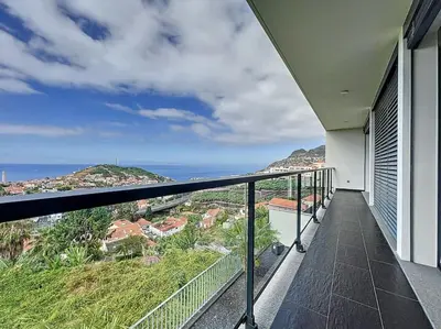 a balcony of a house with a view of the ocean at Villa Ribeiro Real 12 A in Câmara de Lobos