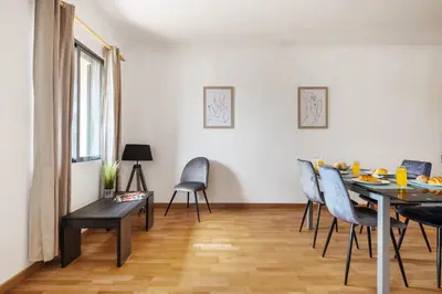 a dining room with a table and chairs at Atlantic Ocean Breeze in Ponta do Sol