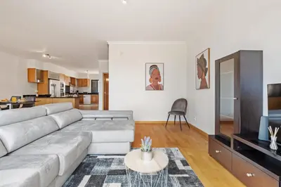 a living room with a couch and a tv at Atlantic Ocean Breeze in Ponta do Sol