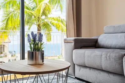 a living room with a couch and a coffee table at Atlantic Ocean Breeze in Ponta do Sol