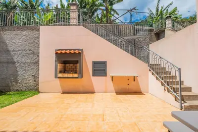 a building with a staircase and a window at Atlantic Ocean Breeze in Ponta do Sol