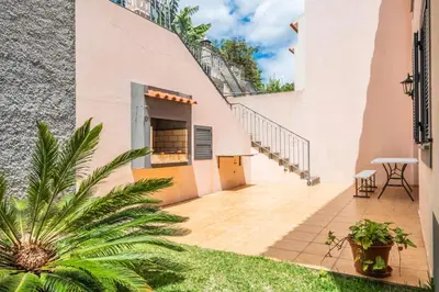 a patio with stairs and plants next to a building at Atlantic Ocean Breeze in Ponta do Sol
