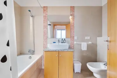 a bathroom with a sink and a tub and a toilet at Atlantic Ocean Breeze in Ponta do Sol