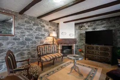 a living room with a stone wall at Villa Roque by An Island Apart in Calheta