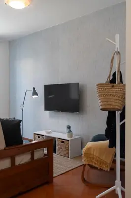 a living room with a flat screen tv on a wall at Apartamento Ilha Dourada by An Island Apart in Porto Santo