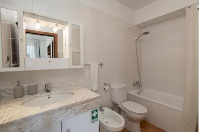 a bathroom with a sink and a toilet and a tub at Apartamento Ilha Dourada by An Island Apart in Porto Santo