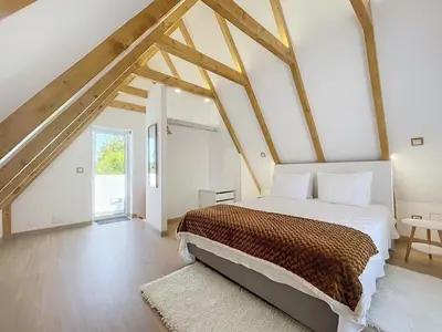 a bedroom with a large bed in a attic at Celeiro do Avô in Santana