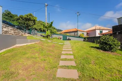a grassy area with a pathway in front of a house at Cantinho do Barreiro - Calheta in Calheta