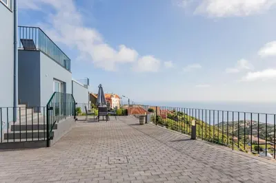 a balcony of a building with a view of the ocean at Cantinho do Barreiro - Calheta in Calheta
