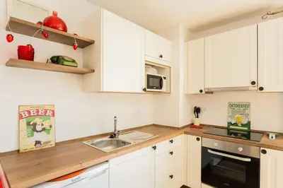 a kitchen with white cabinets and a sink at Cantinho do Barreiro - Calheta in Calheta