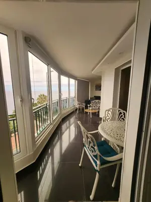 a balcony with a table and chairs and the ocean at Blue Diamond-seaview & free park in Funchal