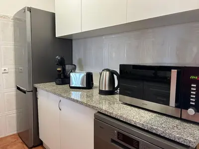 a kitchen with a counter top with a microwave at Golden Island in Porto Santo