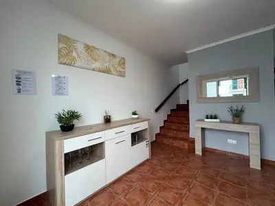 a living room with a staircase and a fireplace at Golden Island in Porto Santo