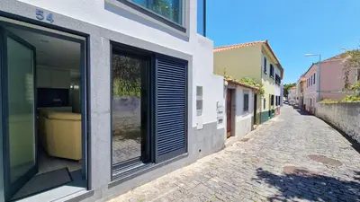 a building with windows on the side of a street at Casa D'Além I & II by LovelyStay in Machico