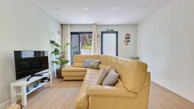 a living room with a couch and a tv at Casa D'Além I & II by LovelyStay in Machico