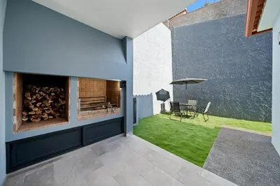 an internal view of a house with a patio with grass at Calheta Paradise Holiday Home - Free Parking & Views in Arco da Calheta