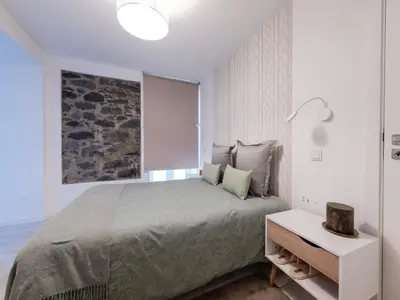 a white bedroom with a bed and a window at Akivillas Calheta Aura in Arco da Calheta