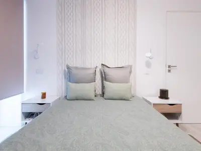 a bedroom with a large bed with two pillows at Akivillas Calheta Aura in Arco da Calheta