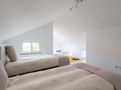 a white bedroom with two beds and a window at Akivillas Calheta Aura in Arco da Calheta