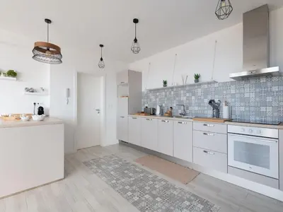 a white kitchen with white cabinets and a counter at Akivillas Calheta Aura in Arco da Calheta