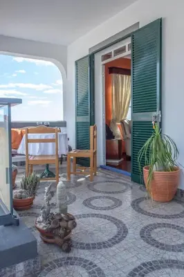 a living room with plants and a room with a bedroom at Casa Menezes Sunrise and Sunset Every Day in Calheta