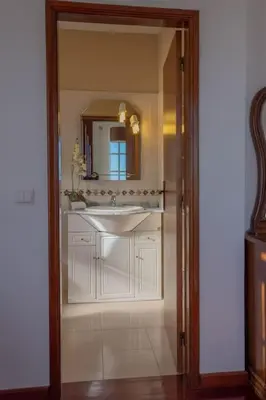 a bathroom with a sink and a mirror at Casa Menezes Sunrise and Sunset Every Day in Calheta