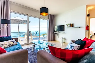 a living room with a view of the ocean at Casa Flora, 2 quartos,vista mar in Arco da Calheta