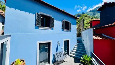 a blue and white house with stairs in front at Casa d Avó 1937, By OP in Senhora do Rosário