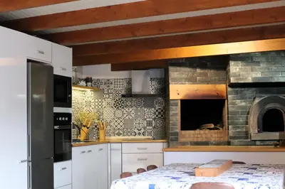 a kitchen with a stone oven and a table at Casa d Avó 1937, By OP in Senhora do Rosário