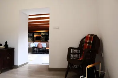 a living room with a chair and a table at Casa d Avó 1937, By OP in Senhora do Rosário
