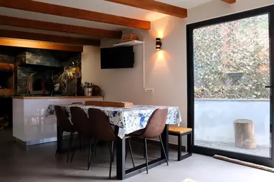 a dining room with a table and chairs and a window at Casa d Avó 1937, By OP in Senhora do Rosário