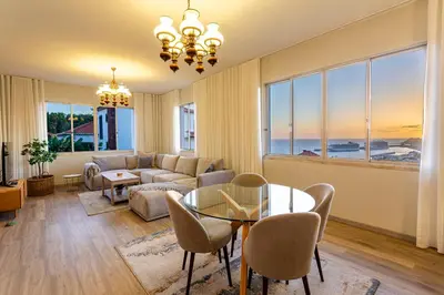 a living room with a couch and a table and chairs at Villa Funchal in Funchal