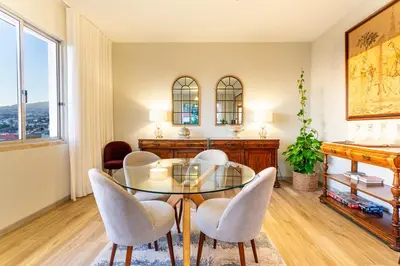 a dining room with a glass table and chairs at Villa Funchal in Funchal